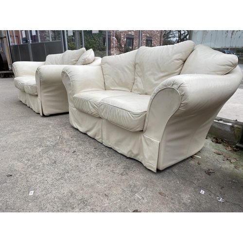 2974 - A PAIR OF CREAM SETTEES