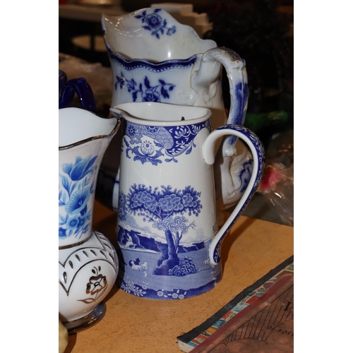 1001 - A COLLECTION OF VINTAGE BLUE AND WHITE JUGS PLUS A VASE - 5 IN TOTAL