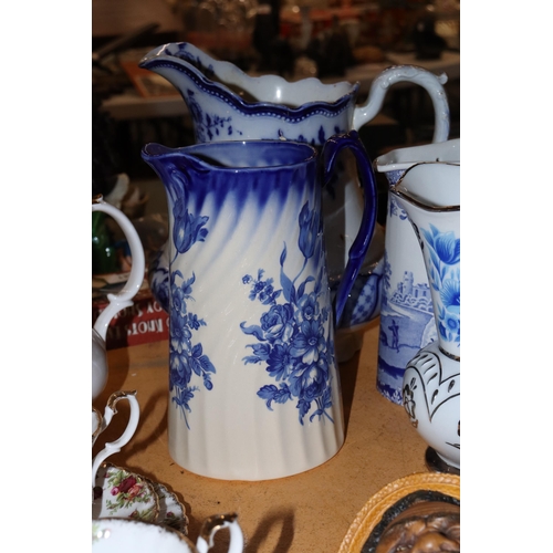 1001 - A COLLECTION OF VINTAGE BLUE AND WHITE JUGS PLUS A VASE - 5 IN TOTAL