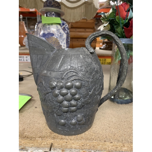 1179 - A VINTAGE PEWTER WINE JUG IN THE FORM OF A BARREL WITH GRAPE AND VINE DECORATION, HEIGHT 19CM