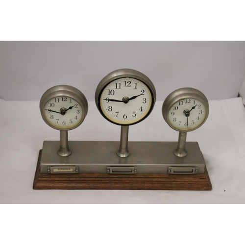 954 - A CLOCKS OF THE WORLD MANTLE CLOCK ON A WOODEN STAND, HEIGHT 24CM, LENGTH 36CM