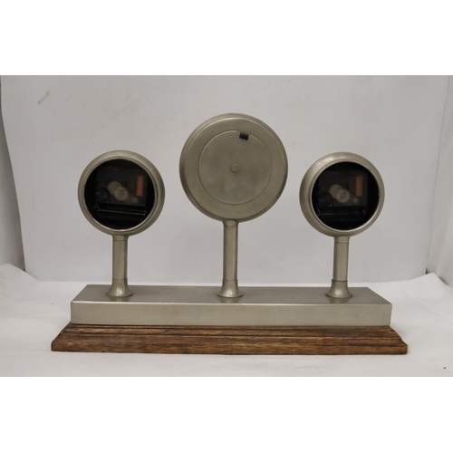 954 - A CLOCKS OF THE WORLD MANTLE CLOCK ON A WOODEN STAND, HEIGHT 24CM, LENGTH 36CM