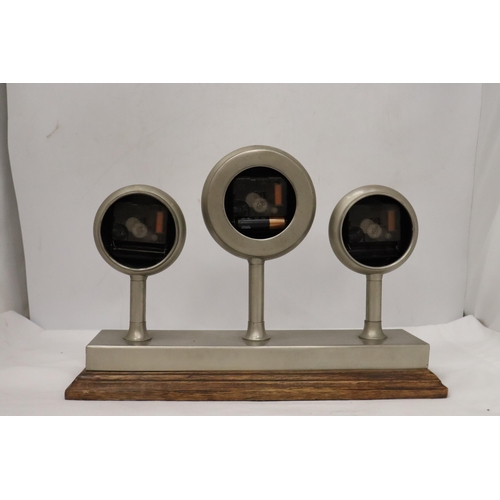 954 - A CLOCKS OF THE WORLD MANTLE CLOCK ON A WOODEN STAND, HEIGHT 24CM, LENGTH 36CM