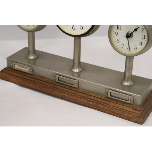 954 - A CLOCKS OF THE WORLD MANTLE CLOCK ON A WOODEN STAND, HEIGHT 24CM, LENGTH 36CM