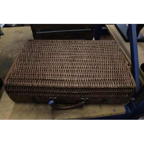 979 - A VINTAGE WICKER TRAVELLING CASE WITH STICKERS, HANDLE A/F