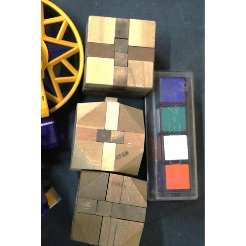 408 - A QUANTITY OF WOODEN PUZZLES PLUS A RUBIKS OBLONG