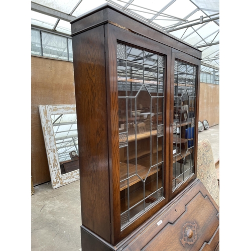 2959 - AN EARLY 20TH CENTURY OAK BUREAU BOOKCASE WITH GLAZED AND LEADED UPPER PORTION 36