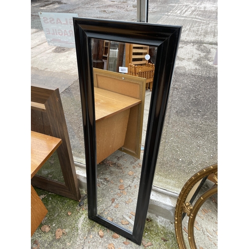 2977 - A BLACK FRAMED WALL MIRROR