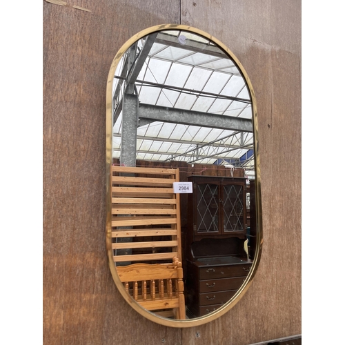 2984 - A MODERN BRASS FRAMED WALL MIRROR, 23