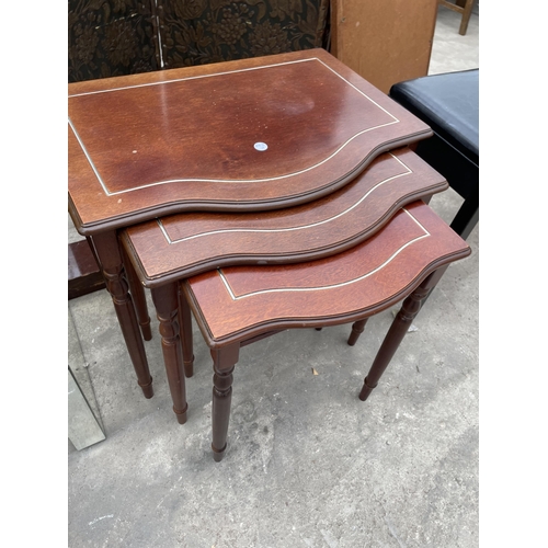 3053 - A BLACK FAUX LEATHER PIANO STOOL AND NEST OF THREE MAHOGANY TABLES