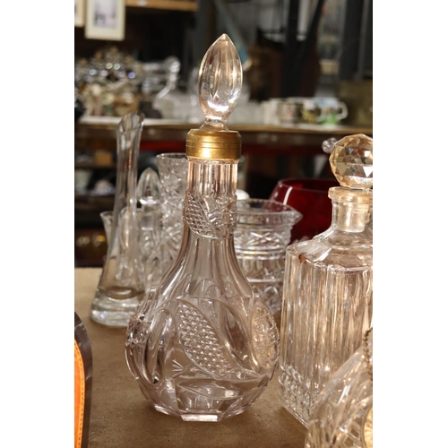 1036 - FOUR CUT GLASS DECANTERS ONE WITH A WHISKEY DECANTER LABEL