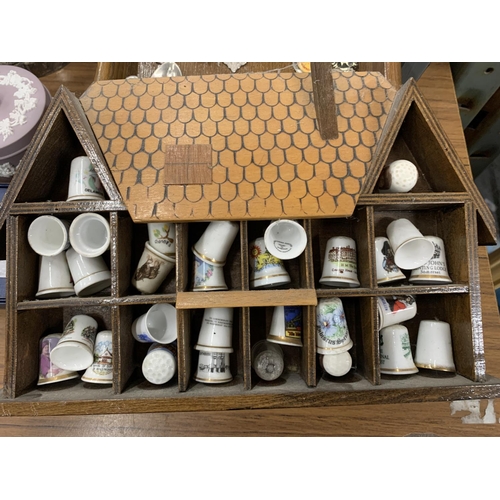 1252 - A QUANTITY OF COLLECTABLE THIMBLES AND SOUVENIR TEASPOONS WITH DISPLAY SHELVES