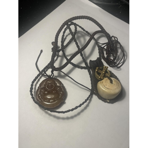 680 - TWO NECKLACES TO INCLUDE A CARVED BUDDHA PENDANT AND A TALISMAN GOOD LUCK AMULET BOTH ON A LEATHER C... 