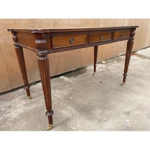 2951 - A REGENCY STYLE MAHOGANY TABLE ENCLOSING THREE DRAWERS AND THREE SHAM DRAWERS WITH INSET LEATHER TOP... 