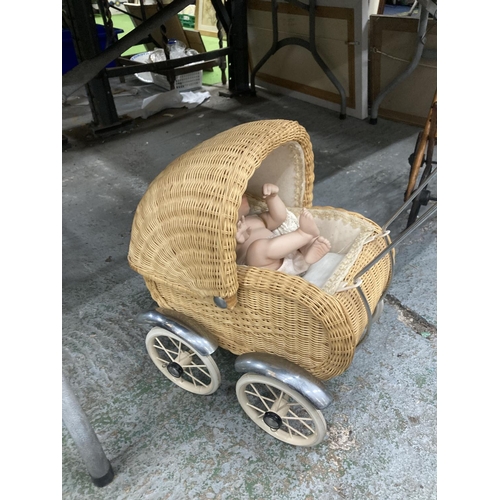 476 - A SMALL VINTAGE WICKER PRAM WITH DOLL