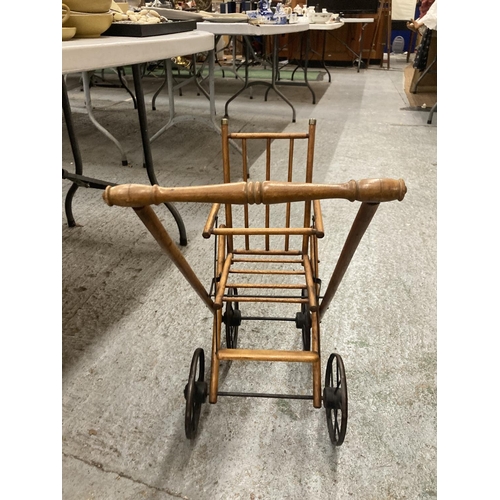 477 - A VINTAGE FOLDING DOLLS PUSH CHAIR