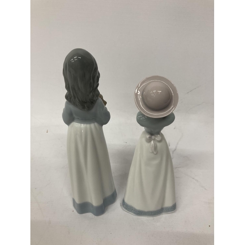 762 - TWO GIRL NAO FIGURINES ONE PRAYING AND ONE HOLDING ADOG