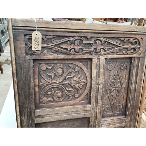 2930 - AN OAK JACOBEAN STYLE CARVED PANEL, 54.5