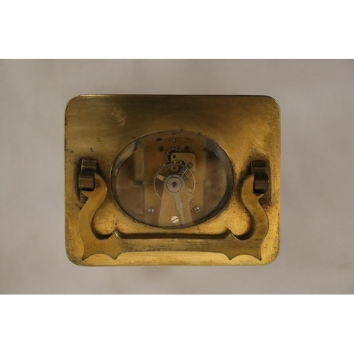120 - A VINTAGE BRASS CARRIAGE CLOCK WITH BEVELED GLASS SECTIONS TO REVEAL UPPER ESCAPEMENT AND INNER MOVE... 
