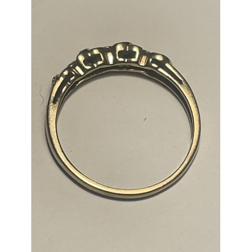 510 - A 9 CARAT GOLD RING WITH CUBIC ZIRCONIA THREE IN A LINE AND THE REST ON TWISTS SIZE S