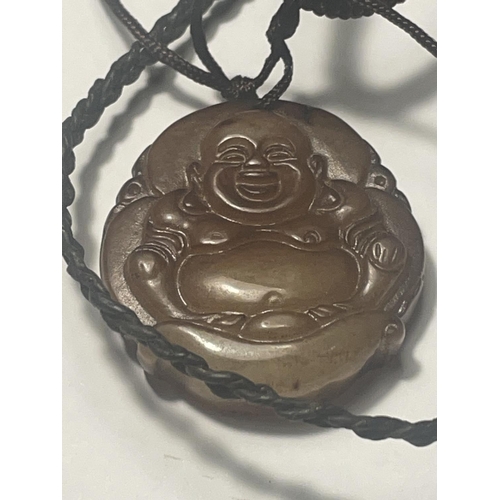 680 - TWO NECKLACES TO INCLUDE A CARVED BUDDHA PENDANT AND A TALISMAN GOOD LUCK AMULET BOTH ON A LEATHER C... 