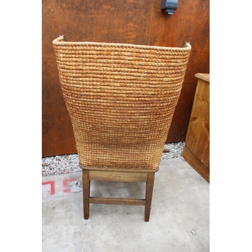 AN OAK ORKNEY CHAIR OF SMALL PROPORTIONS WITH WICKER SEAT AND STITCHED ...