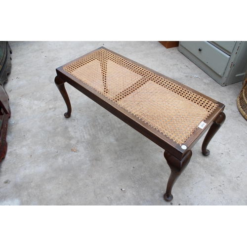 2515 - A MID 20TH CENTURY DUET STOOL ON CABRIOLE LEGS WITH SPLIT CANE SEAT