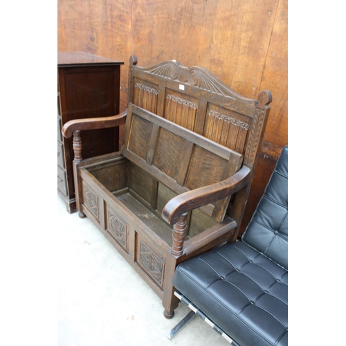 2519 - AN OAK JACOBEAN STYLE SETTLE WITH LINENFOLD BACK, CARVED PANEL FRONT AND LIFT-UP SEAT, 42