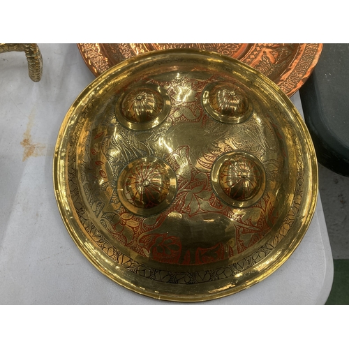 101 - THREE ASIAN STYLE WALL PLAQUES TO INCLUDE A LARGE BRASS CHARGER WITH ENGRAVED DETAIL, DIAMETER 40CM,... 