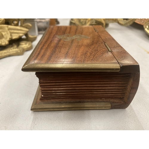 105 - A MAHOGANY BOX IN THE SHAPE OF A BOOK WITH BRASS EDGES AND AN ANCHOR MOTIF TO THE LID