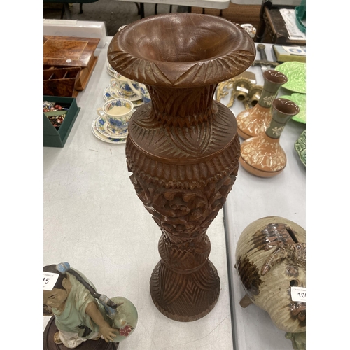 111 - A LARGE HEAVILY CARVED WOODEN VASE, HEIGHT 50CM