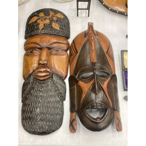 124 - TWO TRIBAL WOODEN WALL MASKS