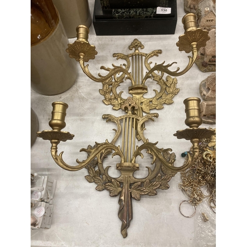 131 - A PAIR OF LARGE ROMAN STYLE BRASS WALL SCONCE CANDLE HOLDERS, 12 INCHES TALL