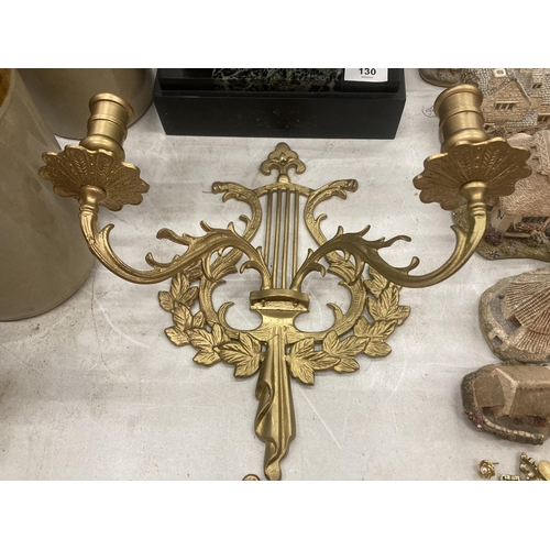 131 - A PAIR OF LARGE ROMAN STYLE BRASS WALL SCONCE CANDLE HOLDERS, 12 INCHES TALL