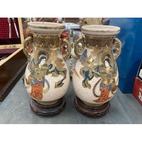 248 - A PAIR OF TWIN HANDLED SATSUMA VASES ON WOODEN STANDS