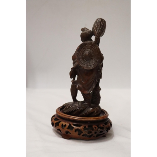 176 - TWO CARVED WOODEN ORIENTAL FIGURES TO INCLUDE A LAUGHING BUDDAH, ON STANDS