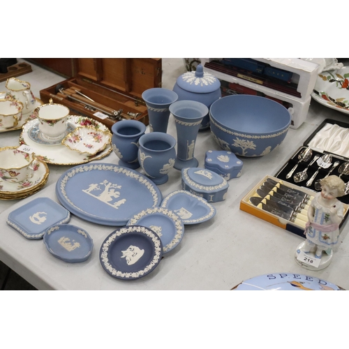 219 - A COLLECTION OF JASPERWARE BLUE AND WHITE WEDGWOOD TO INCLUDE A BISCUIT BARREL, VASES, TINKET BOXES,... 