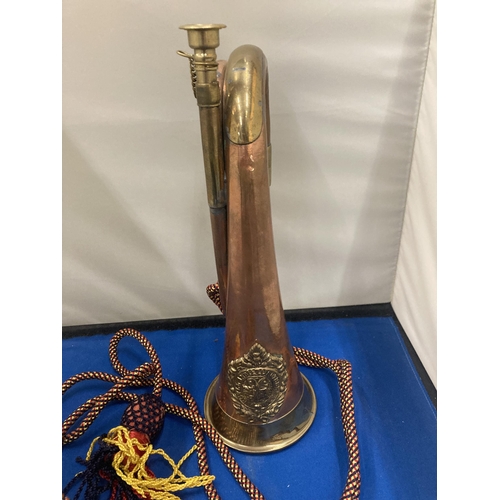 10 - A BRASS AND COPPER 20TH CENTURY BUGLE WITH AN ARGYLE AND SUTHERLAND REGIMENTAL CREST  AND CORD