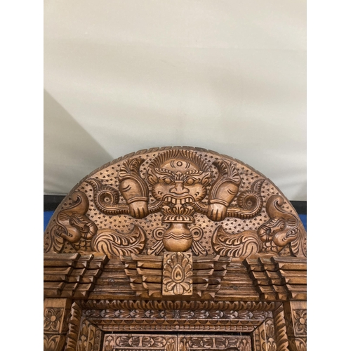 17 - A HEAVILY CARVED ASTAMANGAL DOOR FRAME WALL HANGING