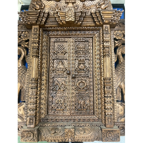 17 - A HEAVILY CARVED ASTAMANGAL DOOR FRAME WALL HANGING