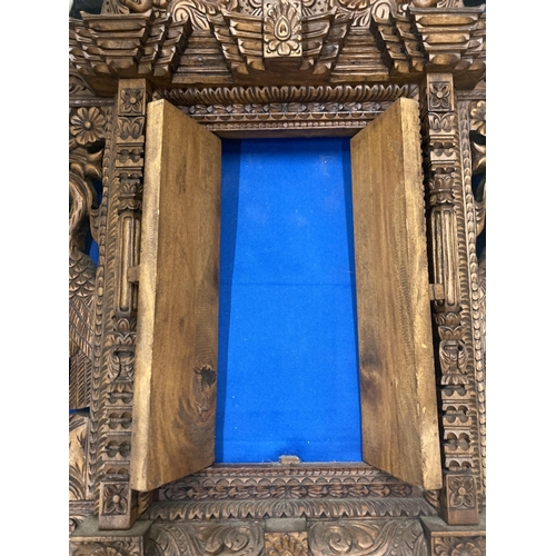 17 - A HEAVILY CARVED ASTAMANGAL DOOR FRAME WALL HANGING