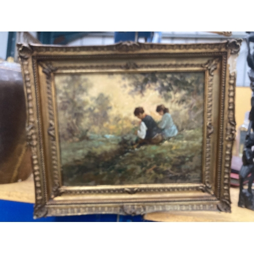 57 - A GILT FRAMED OIL ON BOARD OF TWO CHILDREN BY A RIVER SIGNED 29.5CM X 23CM