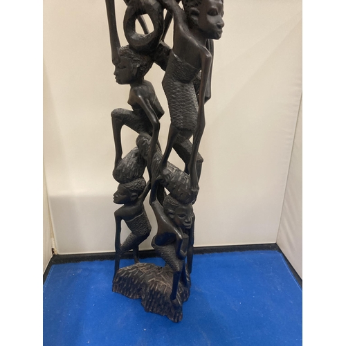 59 - A HEAVILY CARVED AFRICAN EBONY FIGURE APPROX 56CM TALL