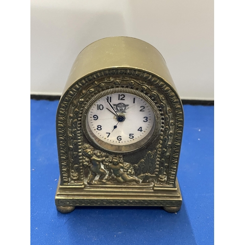 81 - AN ITALIAN CLASSICAL BRASS MANTLE CLOCK WITH CHERUB DESIGN HEIGHT 12CM