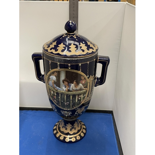 82 - A ROYAL LIMOGES TWIN HANDLED VASE IN BLUE AND GOLD WITH LADIES ON A BALCONY DECORATION HEIGHT 35CM