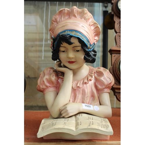 1552 - A HARD PLASTIC FIGURE OF A GIRL READING SHEET MUSIC