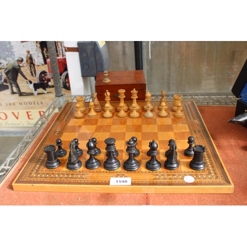 1590 - A VINTAGE CHESS BOARD WITH A CHESS SET (ONE PIECE IS A REPLACEMENT)