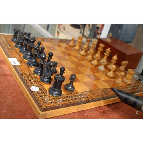 1590 - A VINTAGE CHESS BOARD WITH A CHESS SET (ONE PIECE IS A REPLACEMENT)