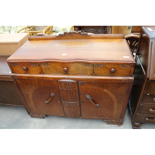 2619 - AN EARLY TWENTIETH CENTURY OAK SIDEBOARD ENCLOSING THREE DRAWERS AND TWO CUPBOARDS, 48