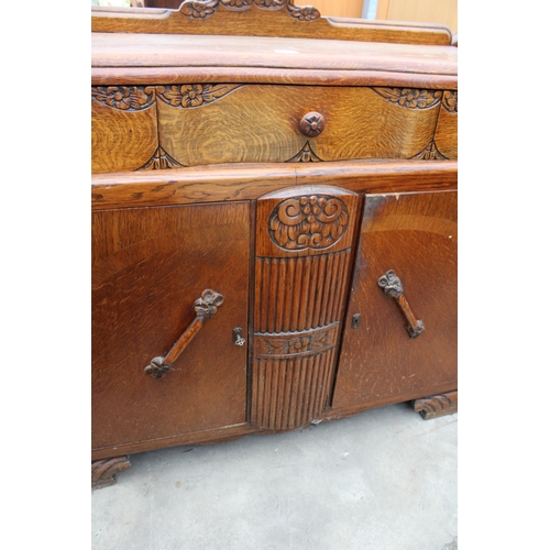 2619 - AN EARLY TWENTIETH CENTURY OAK SIDEBOARD ENCLOSING THREE DRAWERS AND TWO CUPBOARDS, 48